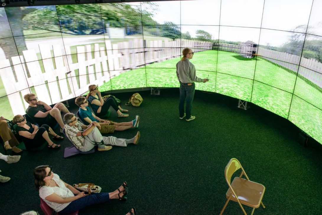 audience immersed in a story at UIC's CAVE2™, a virtual reality environment