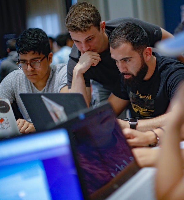 students doing group work on a laptop