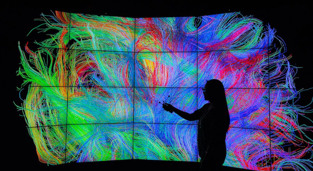 A woman manipulates a data visualization in UIC's Electronic Visualization Lab