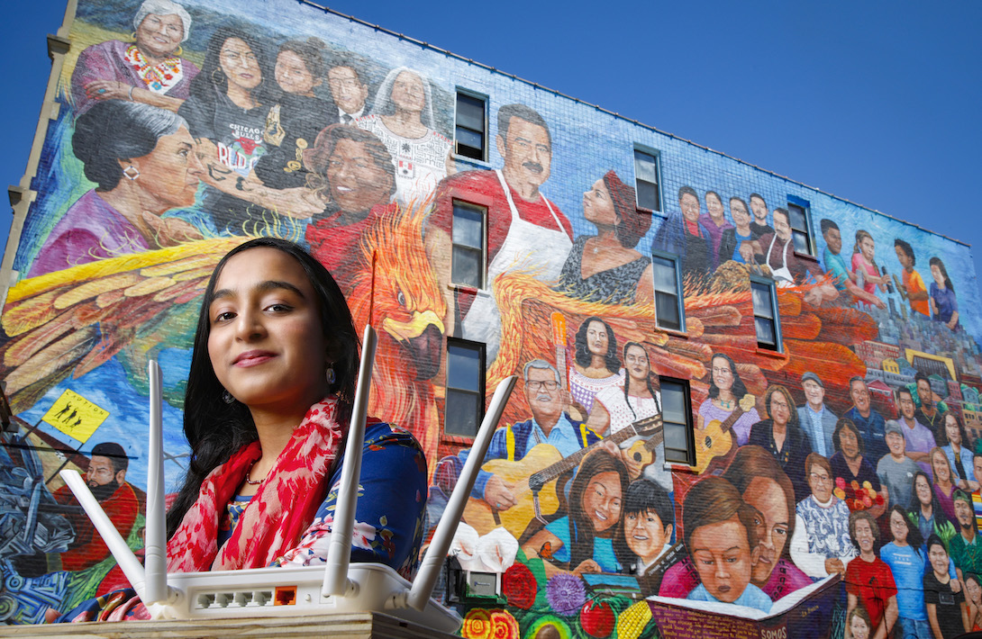 Afifa Nadeem in front of a mural in Pilsen by the artist Pablo Serrano