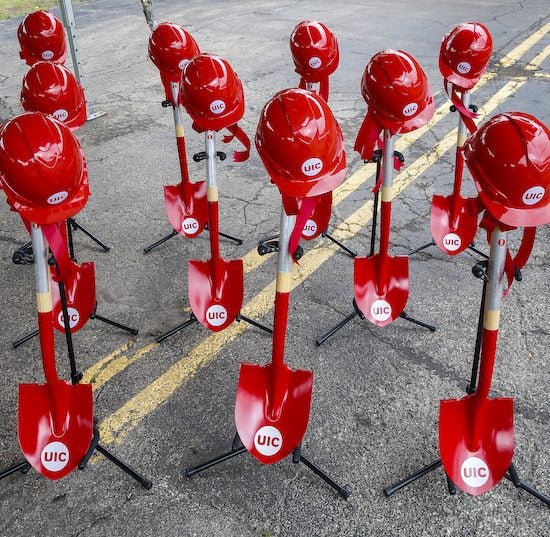 red ceremonial shovels and red UIC hard hats at the groundbreaking ceremony