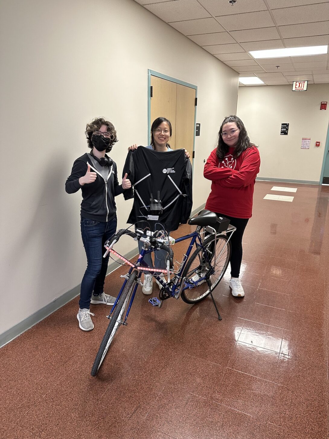 From L: Polly Ruhnke, Annie You, and Emily Mendoza with a bicycle outfitted with the Lite-Bike